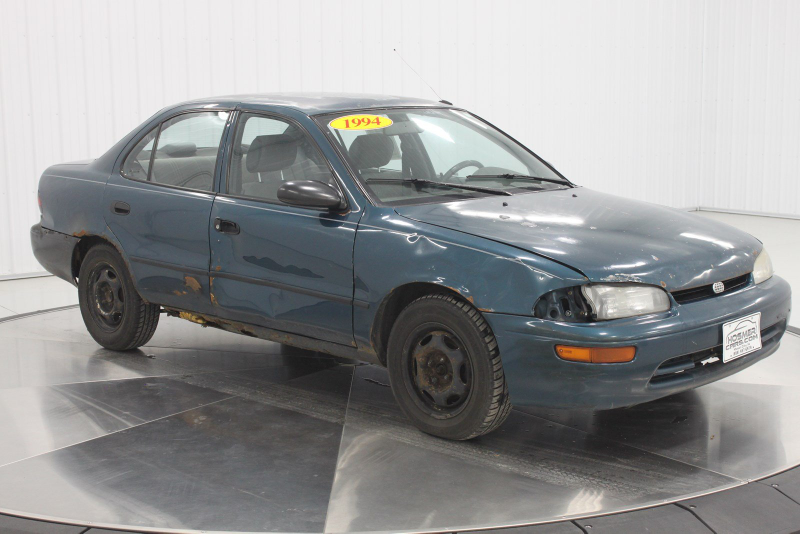 Illustration for article titled Even Rusty Beater Geo Prizms Deserve Nice Photo Shoots At The Dealership